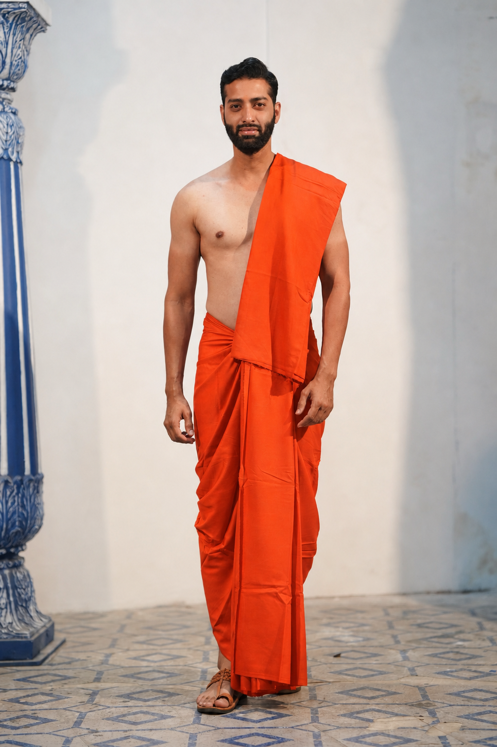 Man wearing a plain orange cotton dhoti with matching khes