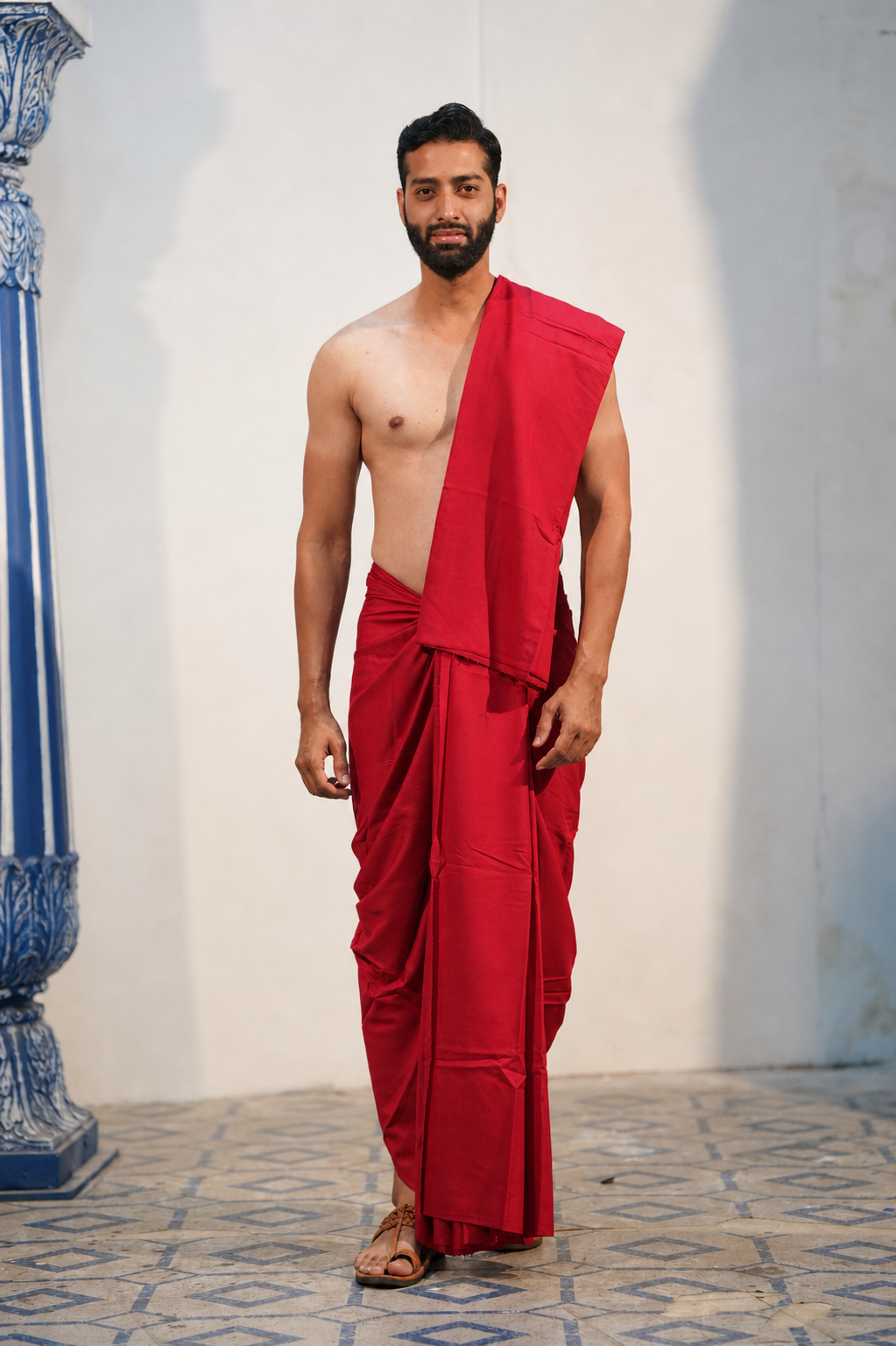 Man wearing a plain red cotton dhoti with matching khes