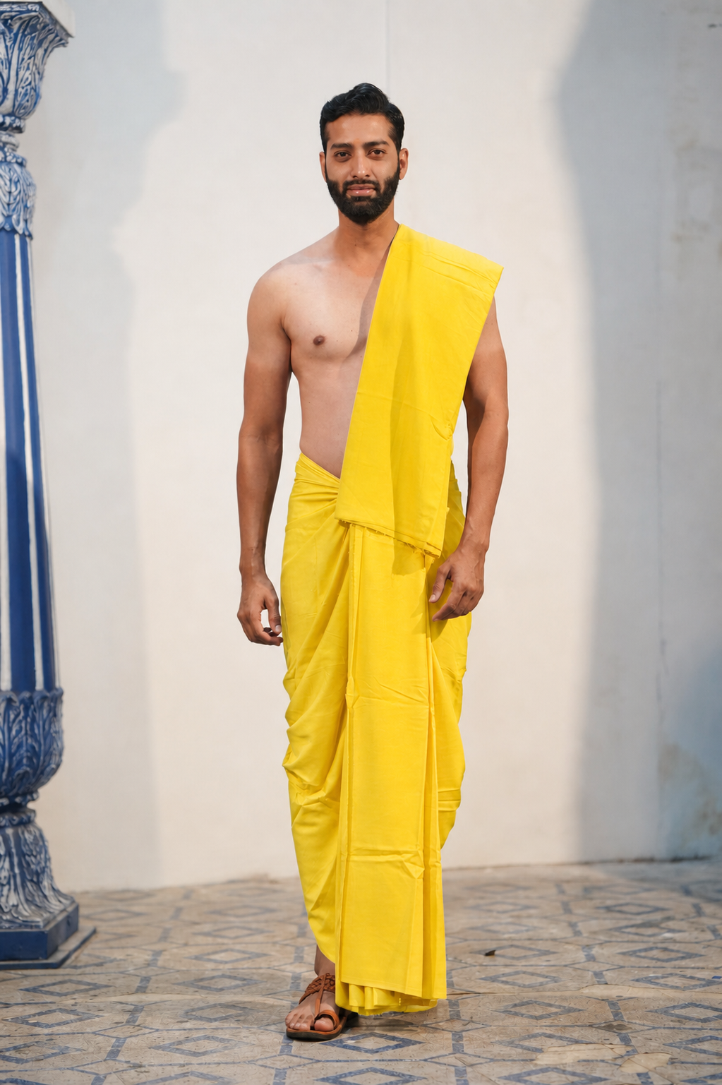 Man wearing a plain yellow cotton dhoti with matching uparana