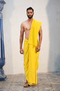 Man wearing a plain yellow cotton dhoti with matching uparana