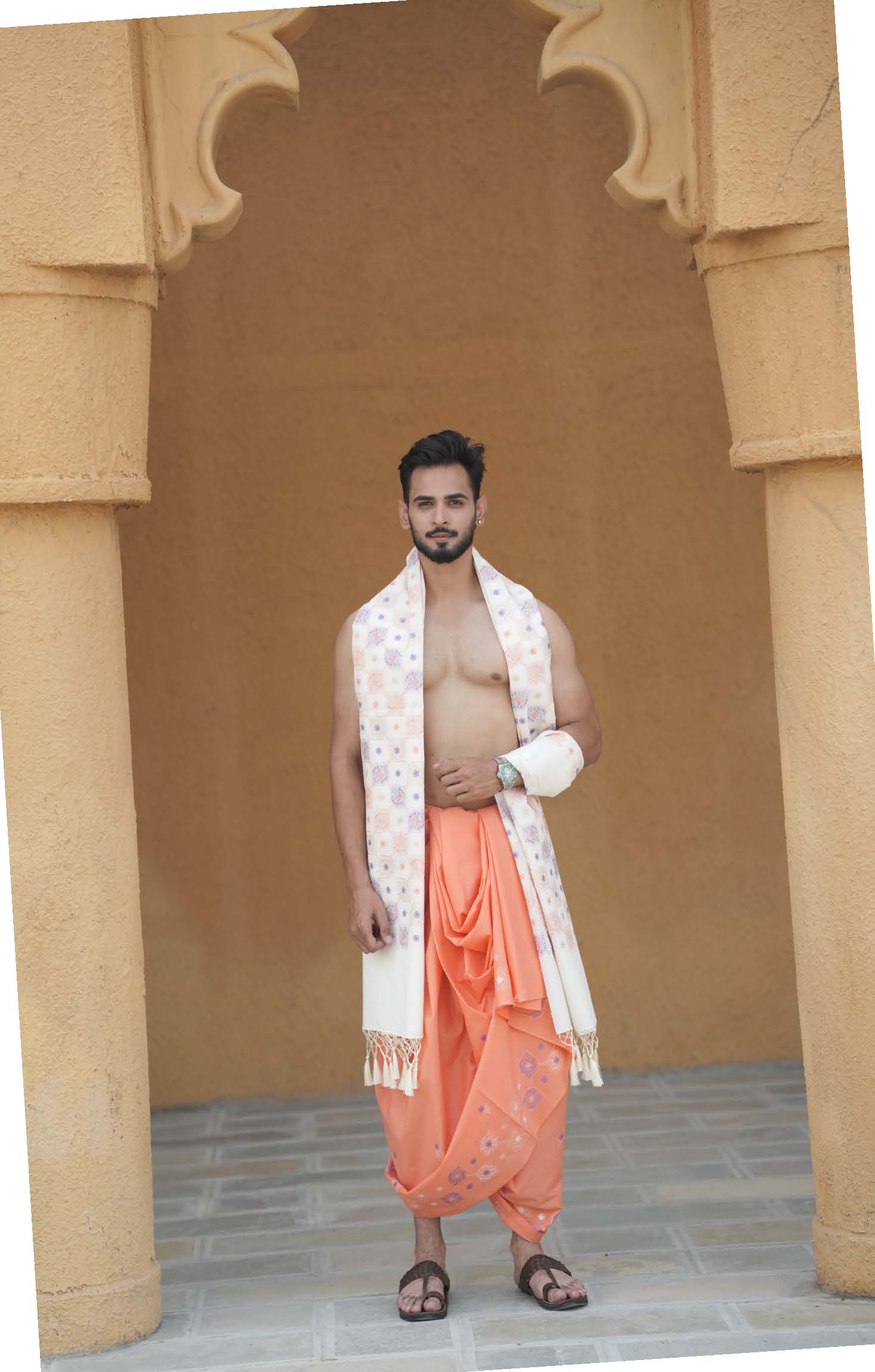 Man wearing a premium embroidered border light orange cotton dhoti with uparana