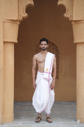 Man wearing a purple border white cotton dhoti with angavastram