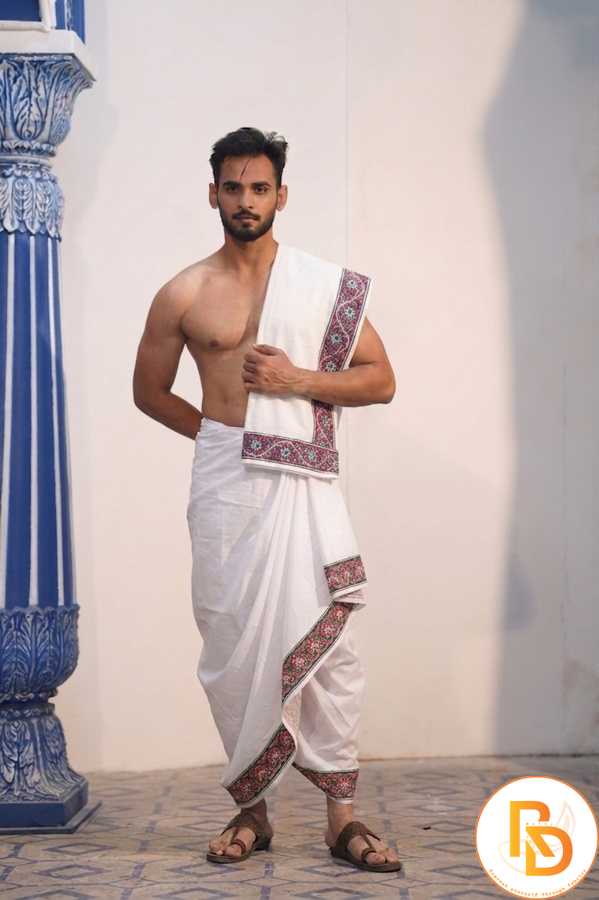 Man wearing a red and green floral border white cotton dhoti with gamcha