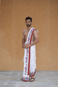 Man wearing a red artistic peacock border white cotton dhoti with khes
