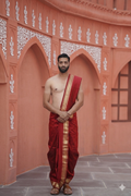 Man wearing a red silk kasab border arificial silk dhoti with uparana