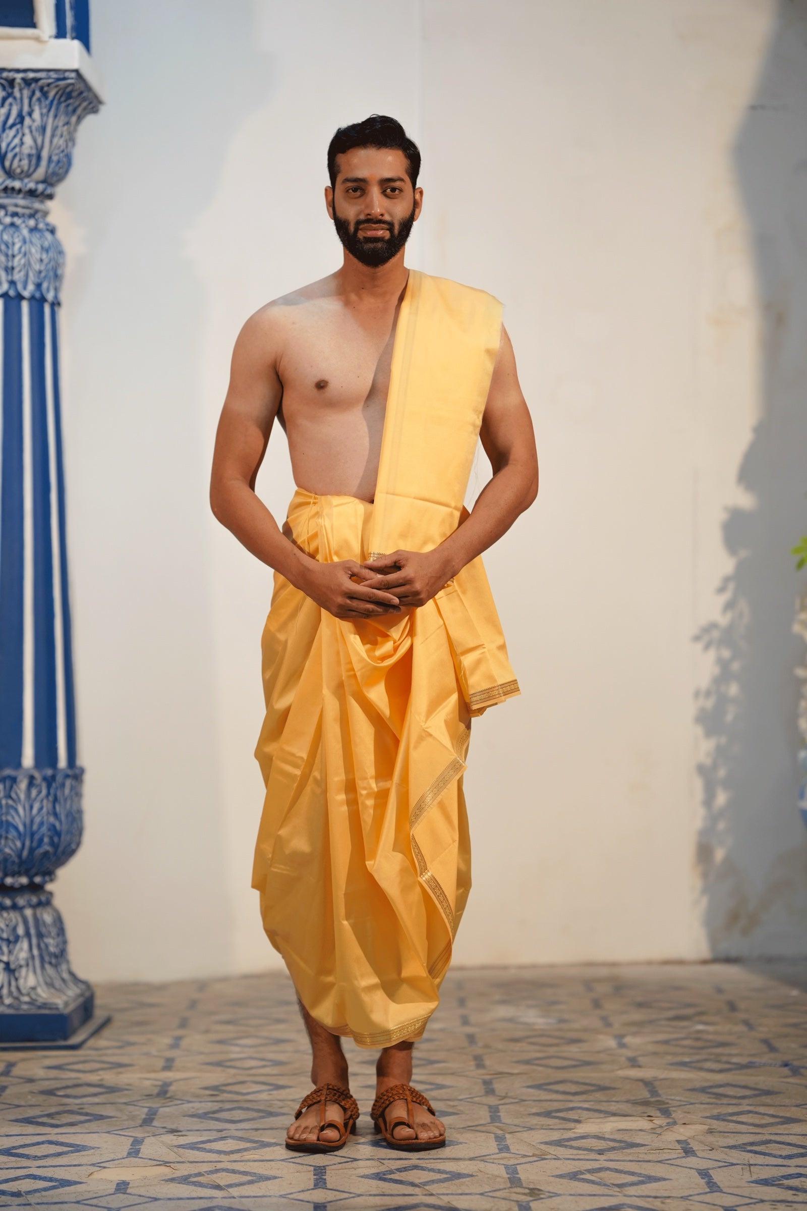 Man wearing a aesthetic rudraksh border artificial silk yellow dhoti with uparana