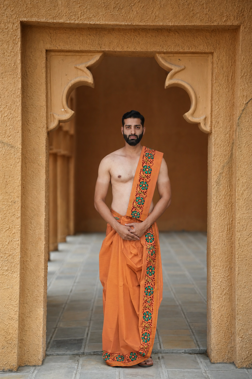 Man wearing a stylish printed orange cotton dhoti with uparana