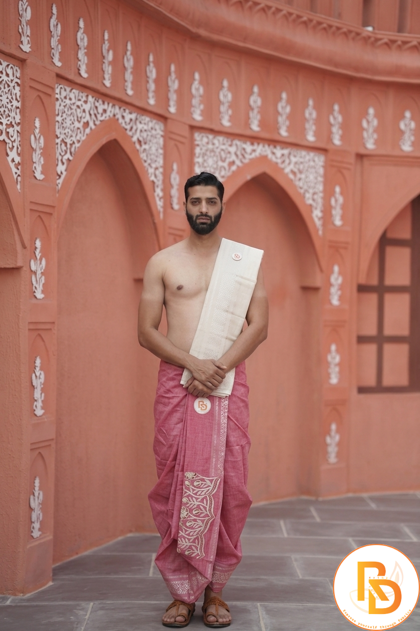 Man wearing a sunflower design border rani pink dhoti with uparana