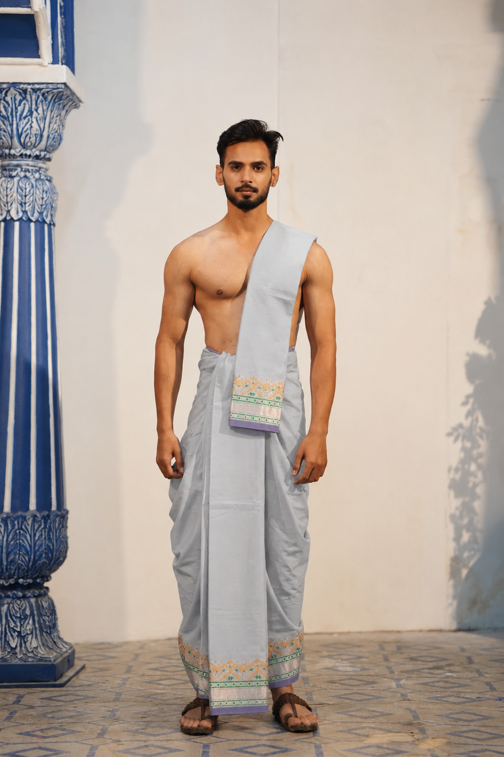 Man wearing a temple motif jacquard border semi silk dhoti with khes