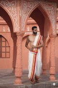 Man wearing a thilani motif printed red border cotton dhoti with uparana