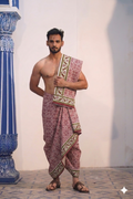 Man wearing a ethnic maroon and green border designed dhoti with uparana