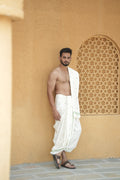 Man wearing a traditional green floral motif border white cotton dhoti with matching khes