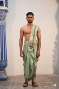 Man wearing a triangle and chain motif border pista green cotton dhoti with matching khes